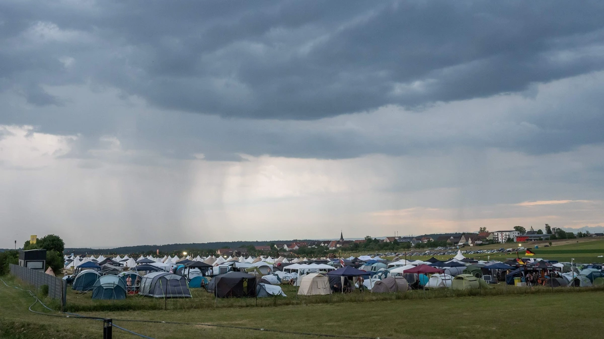 Duits festival onderbroken om zwaar onweer: bezoekers moeten van organisatie schuilen in auto’s