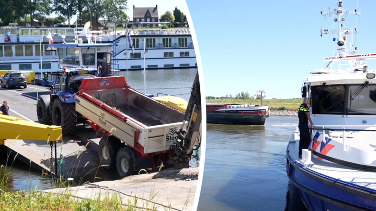 Zware tractor muurvast tussen kade en veerboot in Doornenburg